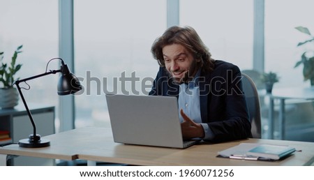 Indoor Portrait of Successful Office Worker Young Businessman throwing Money Rain of Dollars Smiling Celebrating Payday Salary.