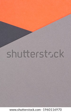 Creative abstract geometric colored paper background in orange, gray, black colors