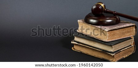 Law concept - law book with a wooden judges gavel on table in a courtroom or law enforcement office. Copy space for text 