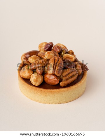 Sweet and delicious milk chocolate tart with nuts