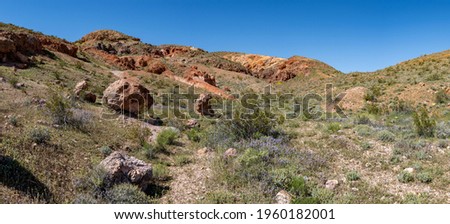 Rocks hills and brush fill the wilderness land in the mojave Desert of Southern California near Ridgecrest. Royalty-Free Stock Photo #1960182001