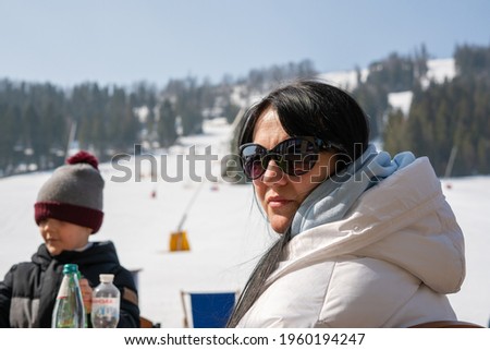 A middle-aged woman is resting at a ski resort. Carpathians. Ukraine