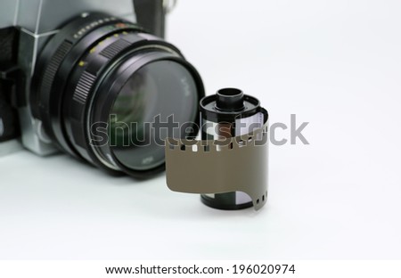 Simple old analog camera with film on white background