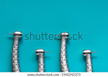 The flat lay of dental high-speed handpieces on the blue background Royalty-Free Stock Photo #1960242373