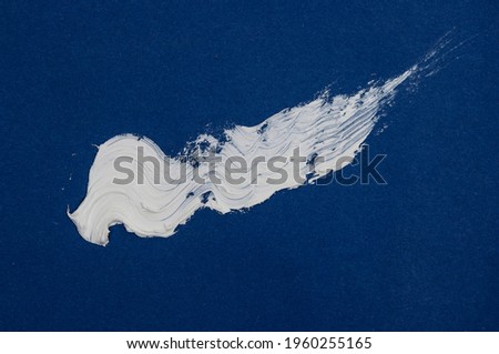 Texture of white brush strokes on blue background.