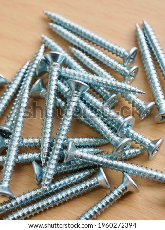 Wooden board background with silver screws