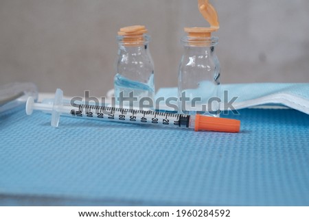 Medicine bottles and syringes on the table blurred background. front view.