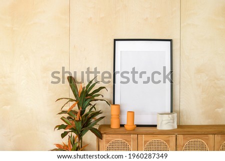 blank picture frame on the table with home decoration in a living room