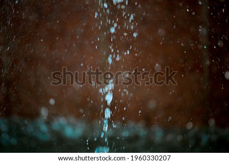 blue water in fountain with water splash in spring