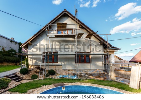 Construction or repair of the rural house, fixing facade, insulation and using color Royalty-Free Stock Photo #196033406