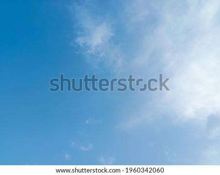 Beautiful blue sky background. Nature photography. Elegant blue sky picture in sunlight. Big white clouds in the blue sky. Wallpaper, texture background