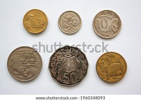 Australian dollar coins of different value, from 5 cents to 2 dollars. Coins featuring kangaroos, platypus, emus, lyre bird and Australian Aboriginal.