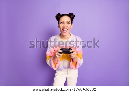 Photo of happy excited crazy smiling woman playing videogames addicted to playstation isolated on purple color background