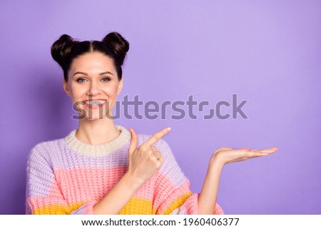 Photo of happy smiling cheerful good mood girl advertising product recommendation isolated on violet color background