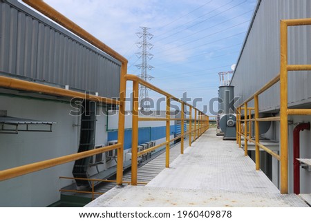 Guardrail walkway on the rooftop of an industrial plant Royalty-Free Stock Photo #1960409878