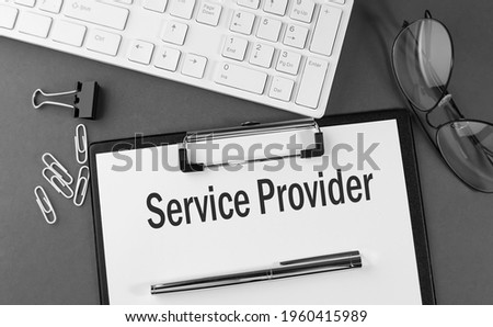 Office paper sheet with text SERVICE PROVIDER with office tols and keyboard. Business