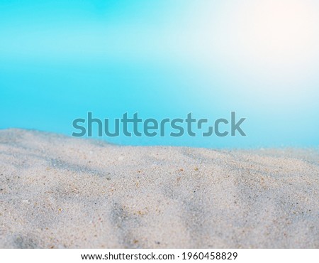 Sea beach sand texture on blue background with Selective focus. Summer background concept. 
