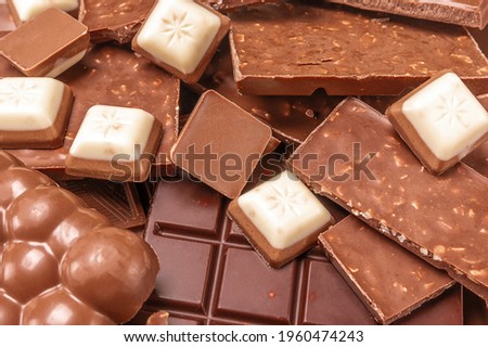 close up chocolate. Top view of various delicious chocolate pieces background. pieces of chocolate bar with chocolate chips