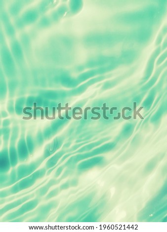 Closeup abstract​ of​ surface​ blue​ water​ reflected​ with​ sunlight​ for​ background. Abstract​ background. Water ​splashed​ for​ background. The​ pattern​ of​ blue​ water. Blue​ water​ in the​ sea​