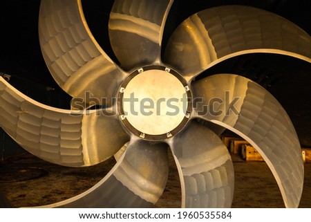 New ship's seven-blade bronze propeller, close-up. Royalty-Free Stock Photo #1960535584