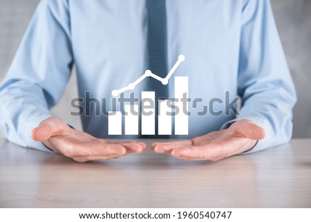 Businessman hold drawing on screen growing graph, arrow of positive growth icon.pointing at creative business chart with upward arrows.Financial, business growth concept.