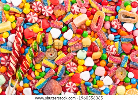 Colorful lollipops and different colored round candy. Top view. Royalty-Free Stock Photo #1960556065