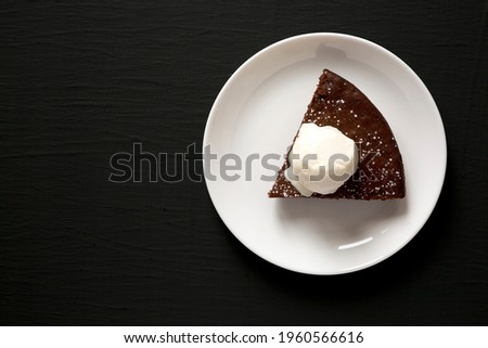 Homemade Chocolate Cake with Ice Cream on a black background, top view. Flat lay, overhead, from above. Space for text