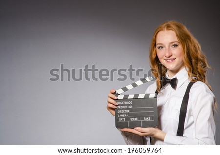 Young woman with movie board  