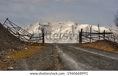 Russia. Republic of Dagestan. Entrance through a wooden gate to a high-altitude pasture near the district center of Tliarata. Royalty-Free Stock Photo #1960668991