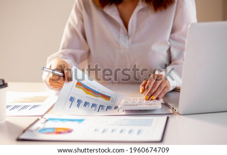 Young businesswoman hands hold documents with financial statistic stock photo,discussion and analysis data the charts and graphs.