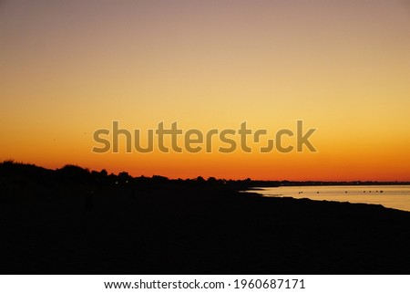 panorama of a sunrise in the morning on the beach with the blue ocean