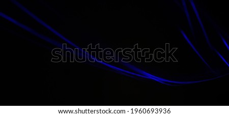 Closeup of Neon blue Spirograph geometric pattern abstract flowing in a isolated Black background. Pendullum Motion.