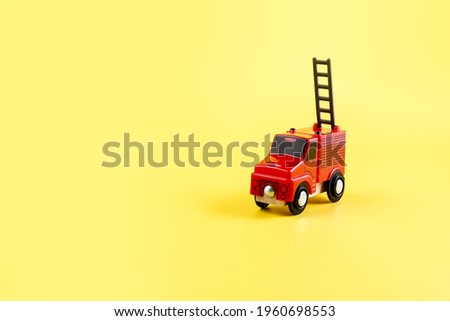 Children's toy, car on a yellow background. Fire engine. Concept. Isolate. Copy space. High quality photo