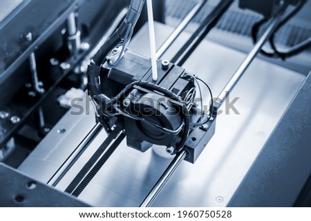 Objects printed by 3d printer. Automatic three dimensional 3d printer performs Royalty-Free Stock Photo #1960750528