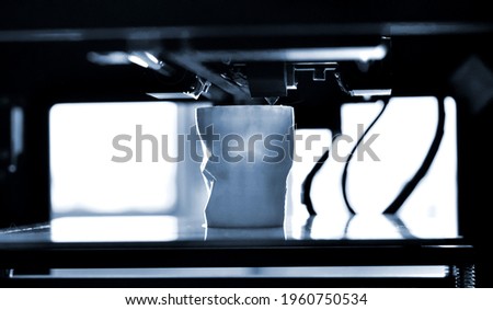 Objects printed by 3d printer. Automatic three dimensional 3d printer performs Royalty-Free Stock Photo #1960750534