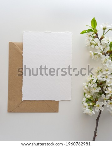 Mockup invitation, blank paper greeting card, floral background, flat lay