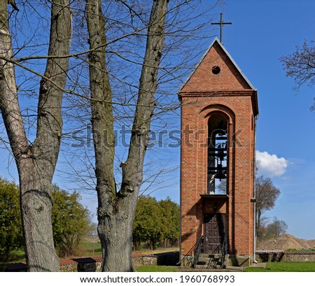 The belfry and its architectural details located next to the Gothic-style Catholic church of St. st. Maciej in the village of Pawłowo in Masovia, Poland.