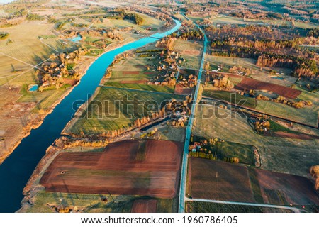 Top view of the Seim River (Ukraine), surrounded by trees and meadows on its banks, view from the top - aerial photo
