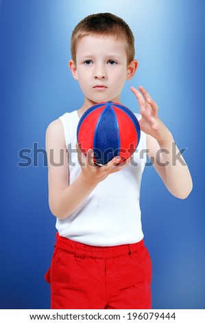 boy with a basketball in his hands in shorts and t-shirt