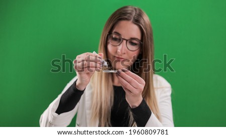 Corona Antigen Self-Test in use - young woman applies a Covid-19 self-test - studio photography