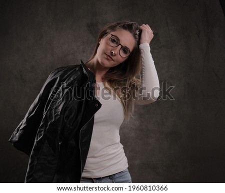 Photo shooting with a young attractive woman in a studio - studio photography