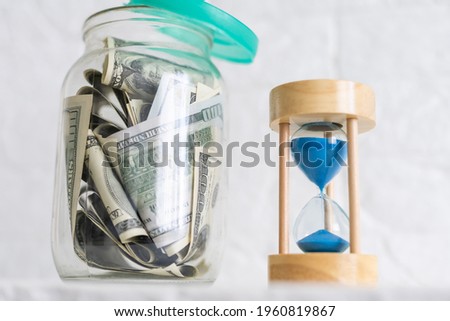 dollars in the bank and hourglass