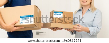medical worker accepting delivery of covid-19 vaccines from deliveryman