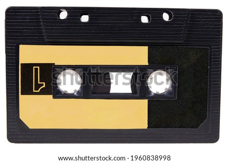 An old cassette tape with music on it. Accessories for storing music recordings. Isolated background.
