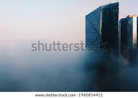 Dubai cityscape with modern glass skyscrapers buildings covered in fog in blue tones, climate weather change Royalty-Free Stock Photo #1960854451
