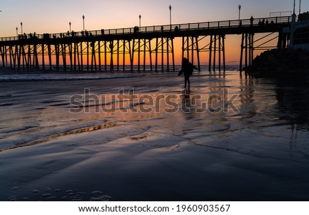 A young girl walking over the sand in Oceanside - California Usa