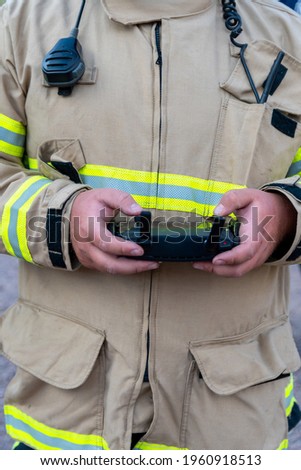 firefighter operating drone in search and rescue. vertical photo