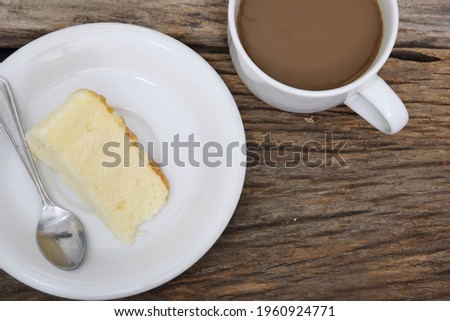 Butter cake homemade and coffee cup on wood table