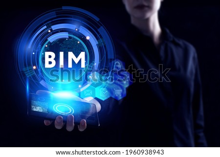 Business, Technology, Internet and network concept. Young businessman working on a virtual screen of the future and sees the inscription: BIM