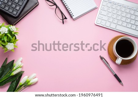 Top view of the working table with stationary equipment coffee mug flower. Copy space.